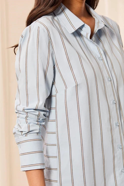 Light blue striped shirt worn by a person on a beige background