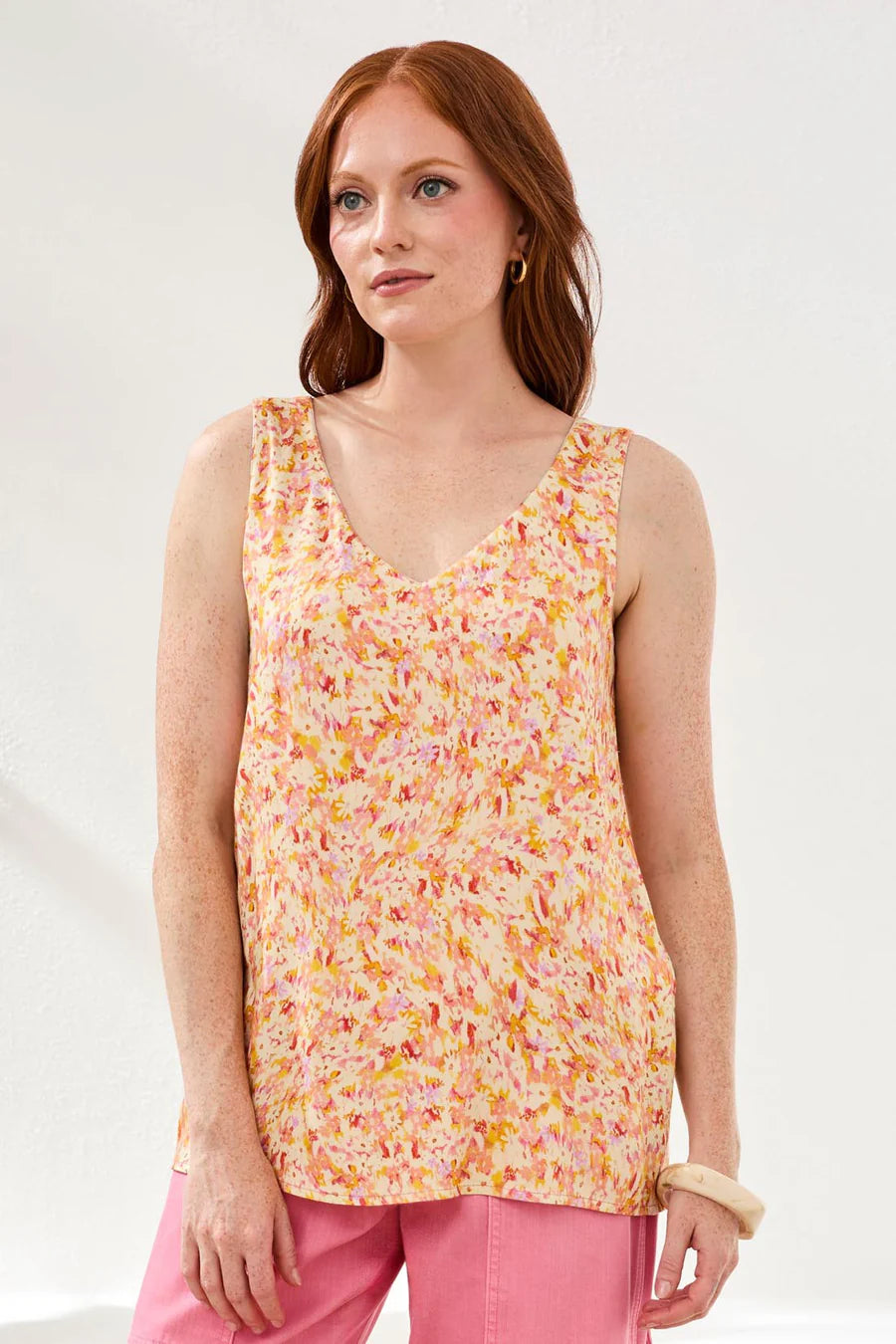 woman wearing floral cami with pink pants