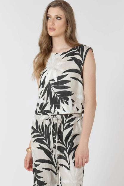 Woman wearing a black and white leaf-patterned outfit on a white background