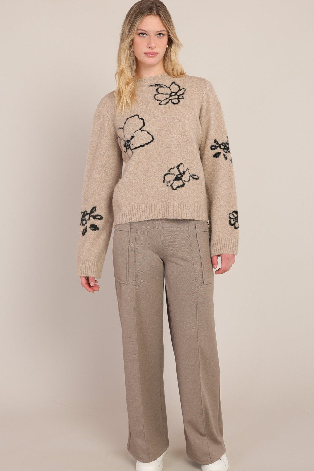 woman wearing floral sweater
