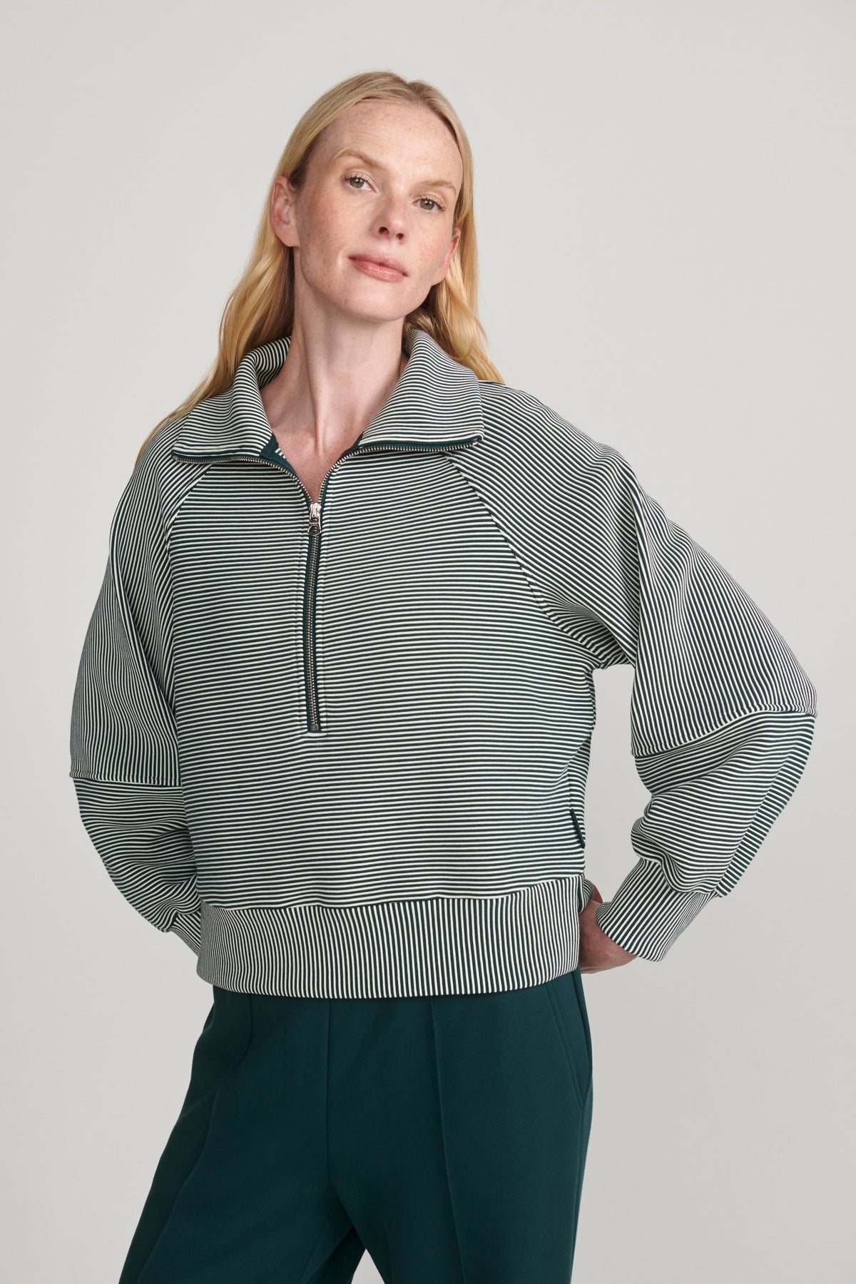 woman wearing green sweatshirt 