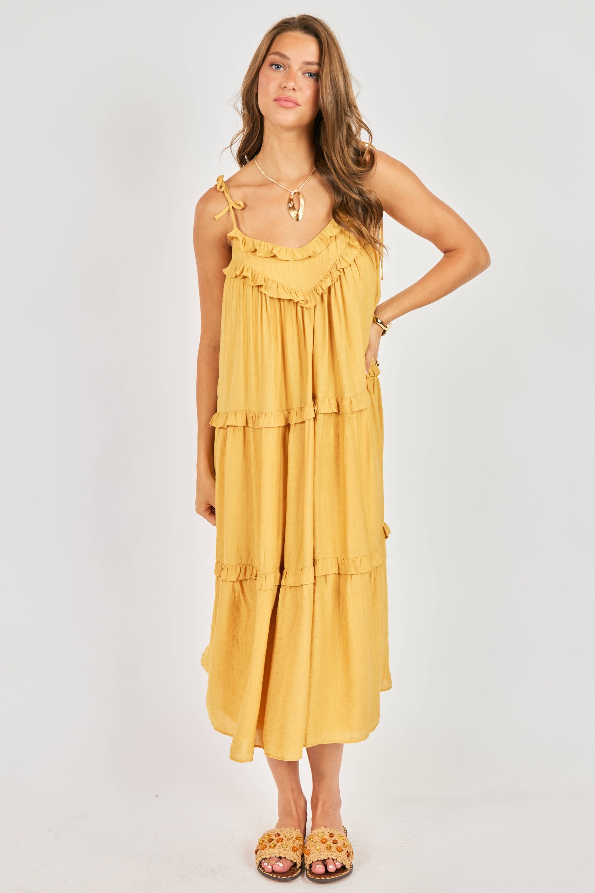 Woman wearing a yellow dress on a white background