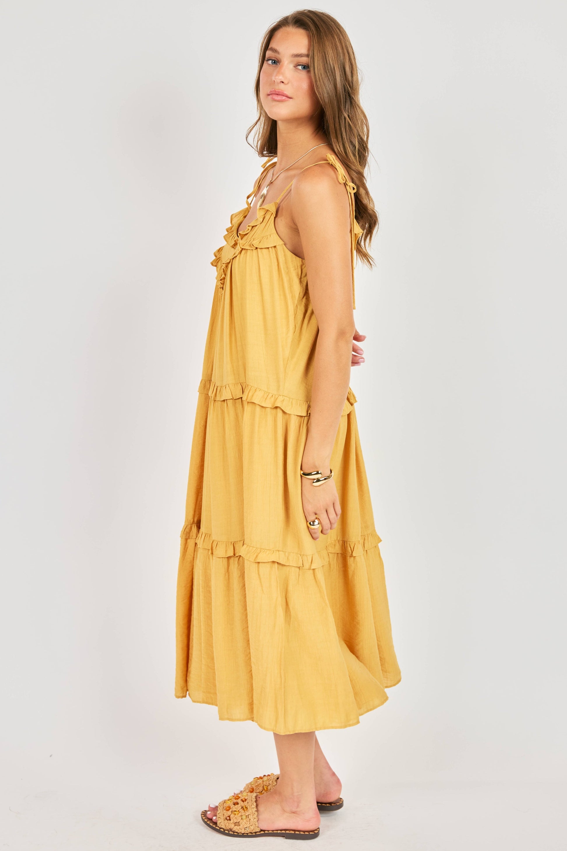 Woman wearing a yellow dress against a white background