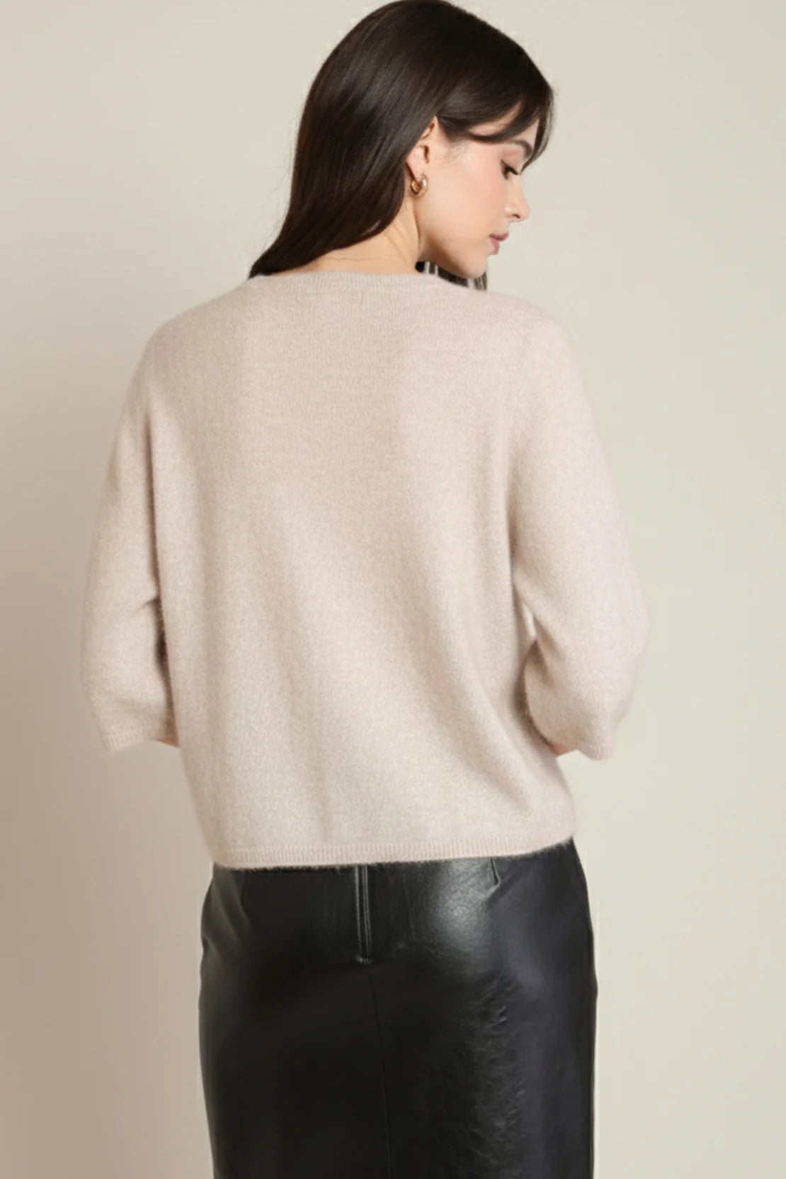 back of woman in pink sweater