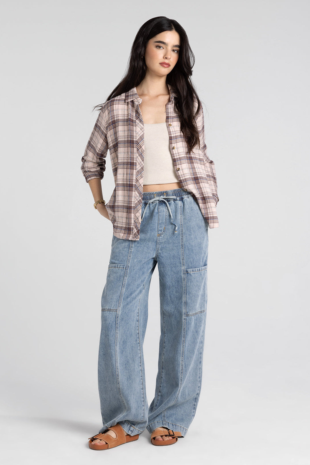 woman wearing plaid button up with jeans 