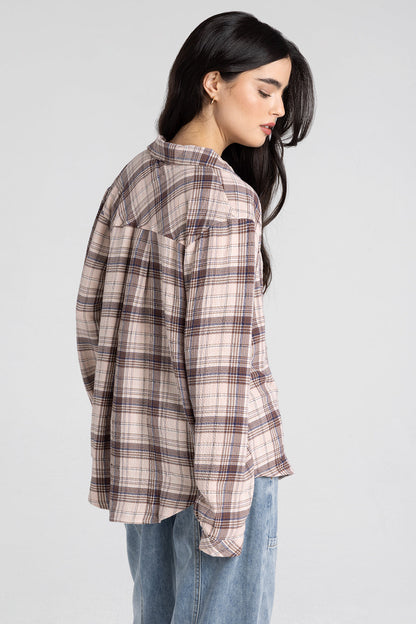 woman wearing plaid button up with jeans 