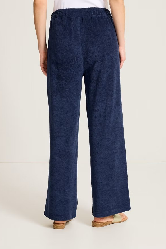 Navy blue wide-leg pants worn by a person on a white background