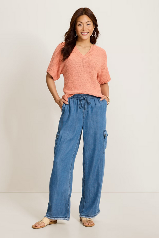 woman wearing denim pants with coral top 